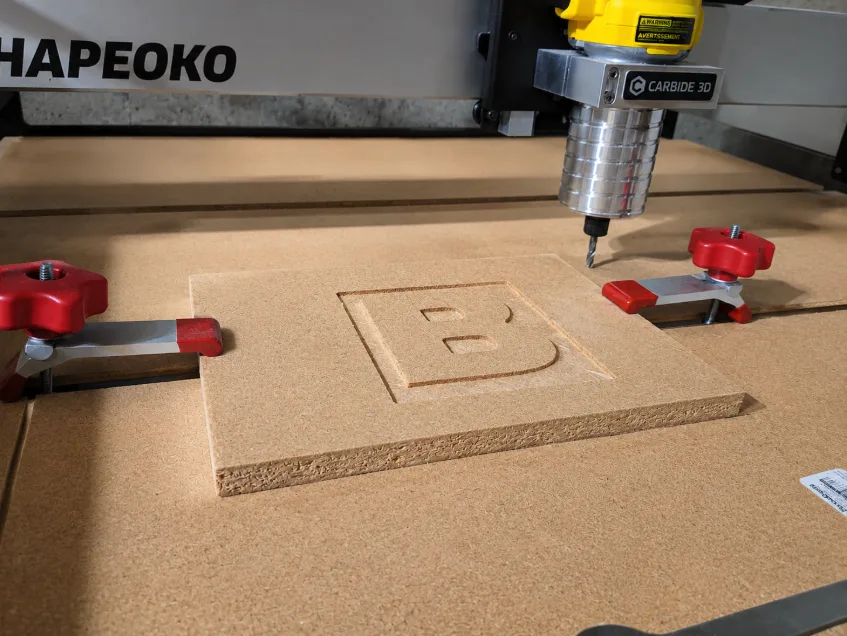 Shapeoko CNC router carving a letter B in Dave Horsley's woodshop